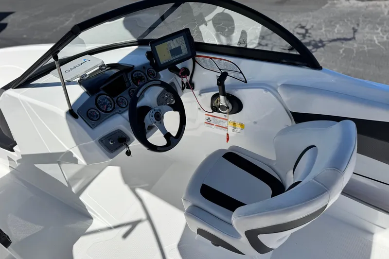 Slide: The Image of Cockpit of 2020 Tahoe 500 TF boat with steering wheel and Garmin navigation system. - 25