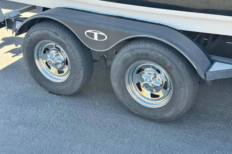 Slide: The Image of Trailer wheels of a 2020 Tahoe 500 TF boat on asphalt surface. - 29