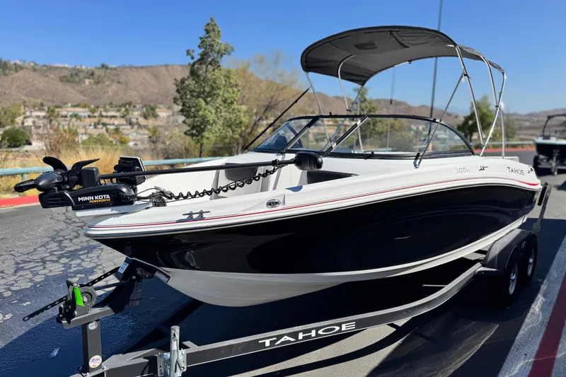Slide: The Image of 2020 Tahoe 500 TF boat on trailer, featuring Minn Kota motor, parked outdoors. - 3