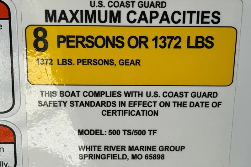 Slide: The Image of 2020 Tahoe 500 TF boat capacity label, 8 persons or 1372 lbs, U.S. Coast Guard compliant. - 31