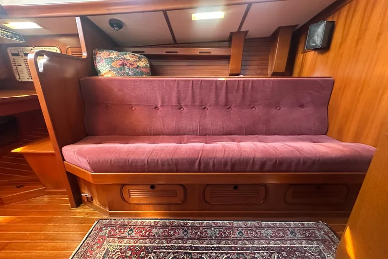 Slide: The Image of Cozy interior of 1986 Mason 33 sailboat with plush seating and wooden accents. - 25
