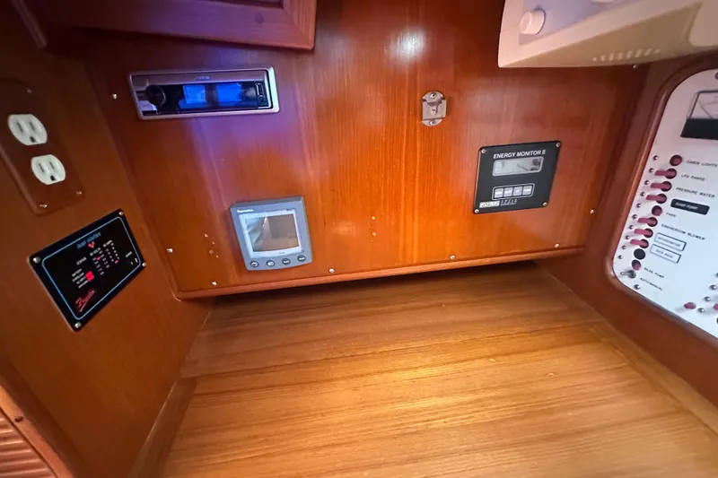 Slide: The Image of 1986 Mason 33 yacht control panel with energy monitor and electrical outlets. - 37