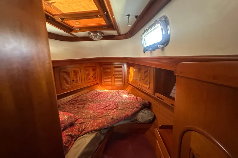 Slide: The Image of Cozy cabin interior of 1986 Mason 33 sailboat with wooden finish and porthole window. - 45