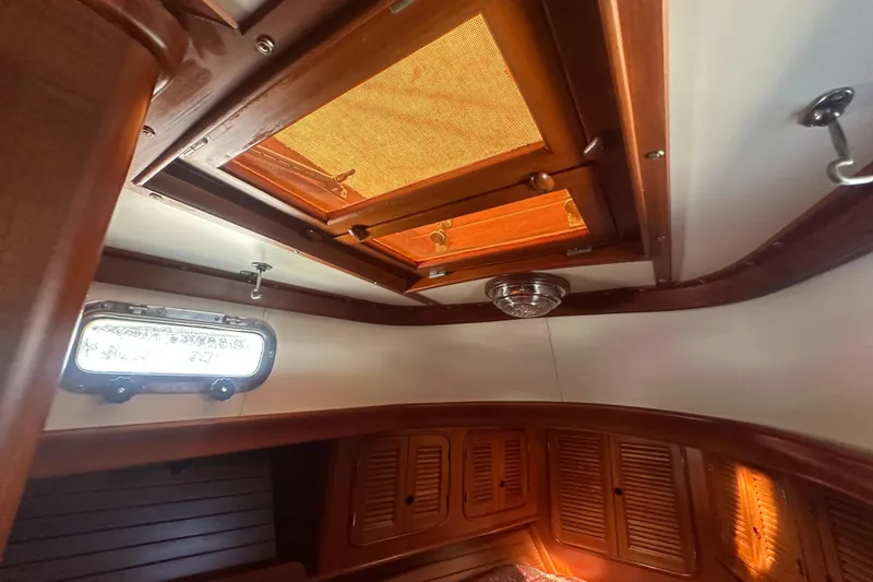 Slide: The Image of Interior of a 1986 Mason 33 sailboat with wooden finish and skylight. - 46