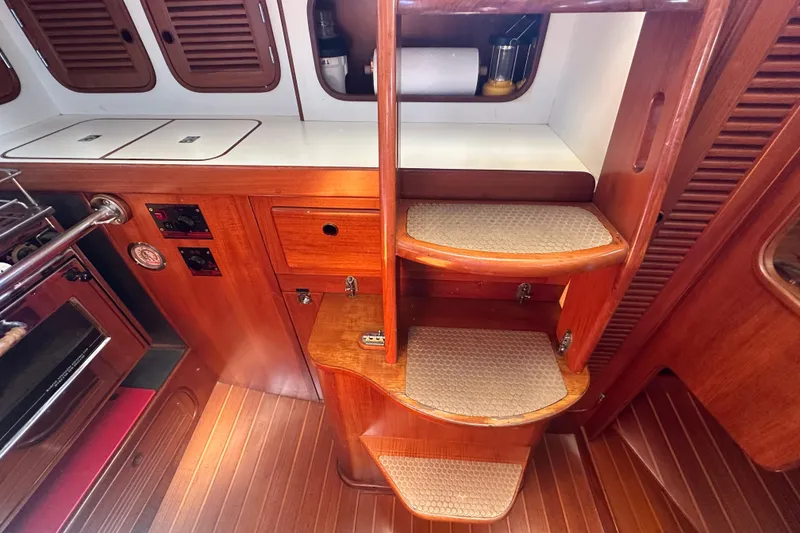 Slide: The Image of 1986 Mason 33 yacht interior with wooden steps and cabinetry. - 54