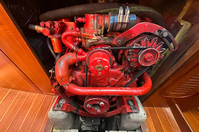 Slide: The Image of Red engine of a 1986 Mason 33 boat, showcasing intricate mechanical components. - 55