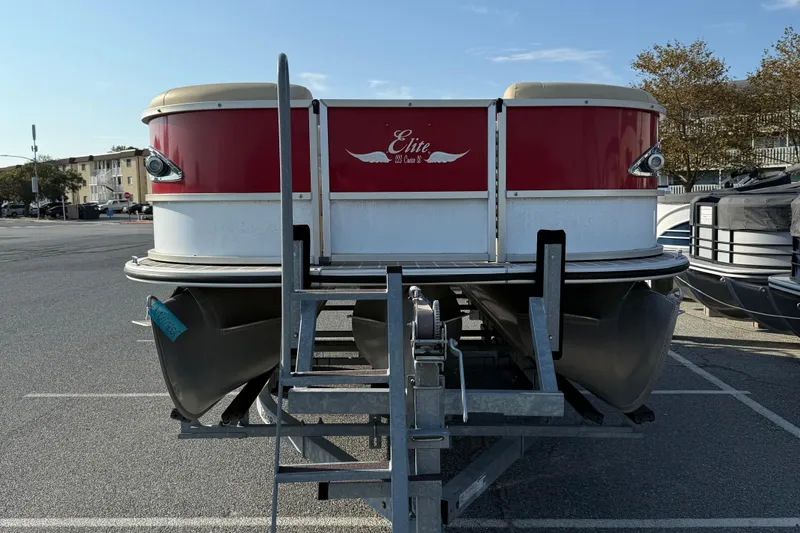 Slide: The Image of 2019 Bentley Pontoons 223 Cruise, red and white, parked on a trailer in a lot. - 2