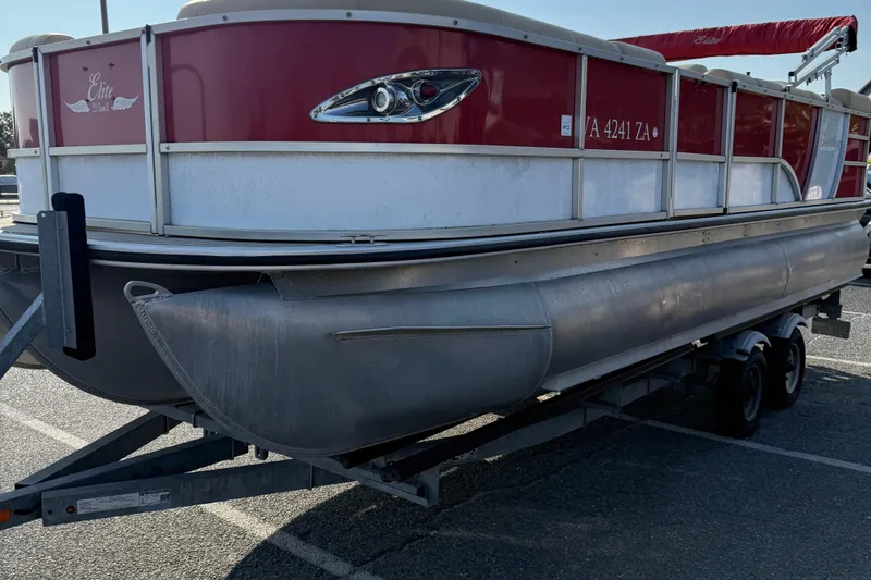 Slide: The Image of 2019 Bentley Pontoons 223 Cruise on trailer, red and white exterior, parked in lot. - 3