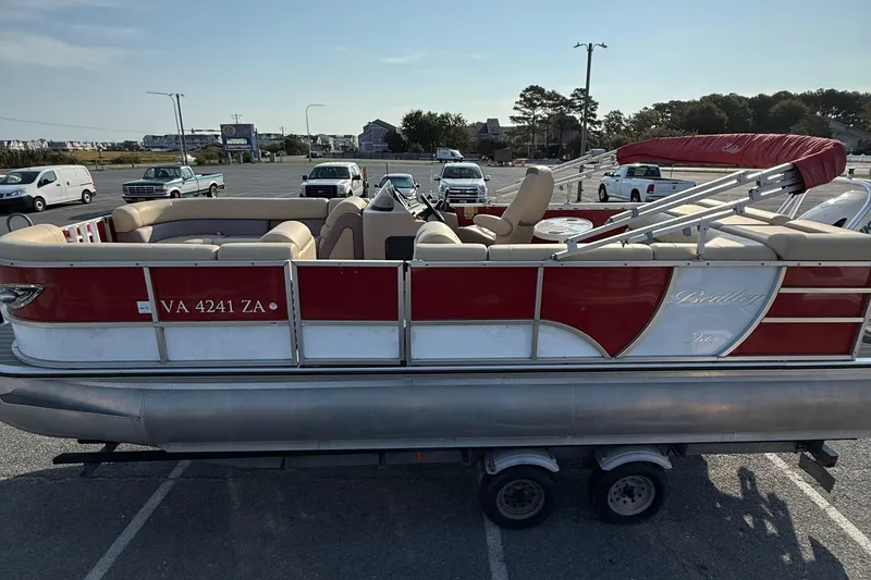 Slide: The Image of 2019 Bentley Pontoons 223 Cruise in parking lot, red and beige design, on trailer. - 4