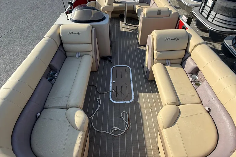Slide: The Image of 2019 Bentley Pontoons 223 Cruise interior with beige seating and cup holders. - 5