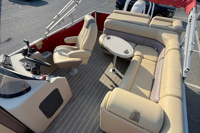 Slide: The Image of 2019 Bentley Pontoons 223 Cruise interior with beige seating and steering console. - 6