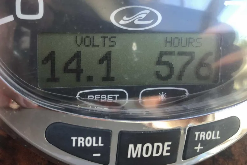 Slide: The Image of Close-up of a 2005 Sea Ray 280 Sundancer gauge showing 14.1 volts and 576 hours. - 10