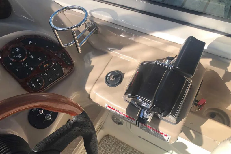 Slide: The Image of Control panel of a 2005 Sea Ray 280 Sundancer boat with steering wheel and throttle. - 14