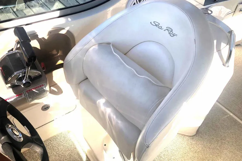 Slide: The Image of Captain's seat and controls of a 2005 Sea Ray 280 Sundancer boat. - 16
