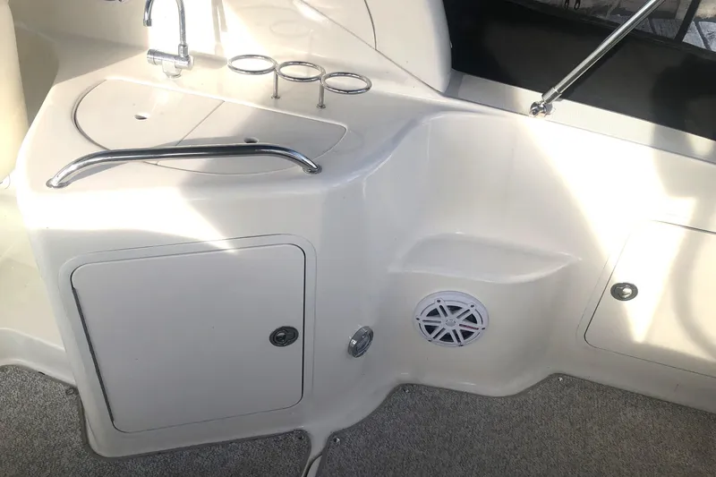 Slide: The Image of 2005 Sea Ray 280 Sundancer boat interior with sink, storage, and speaker. - 17