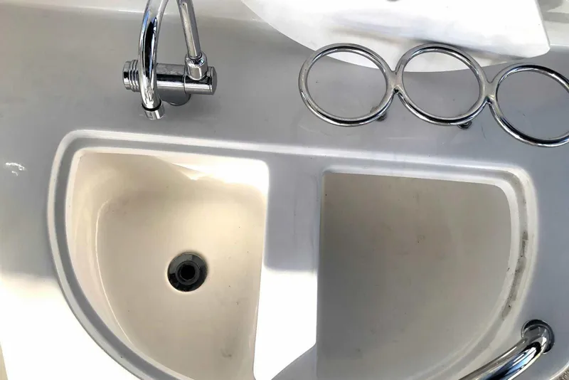 Slide: The Image of 2005 Sea Ray 280 Sundancer sink with chrome faucet and cup holders. - 18