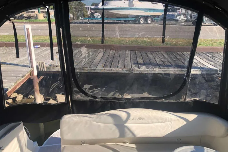 Slide: The Image of Interior view of a 2005 Sea Ray 280 Sundancer boat with dockside scenery. - 20