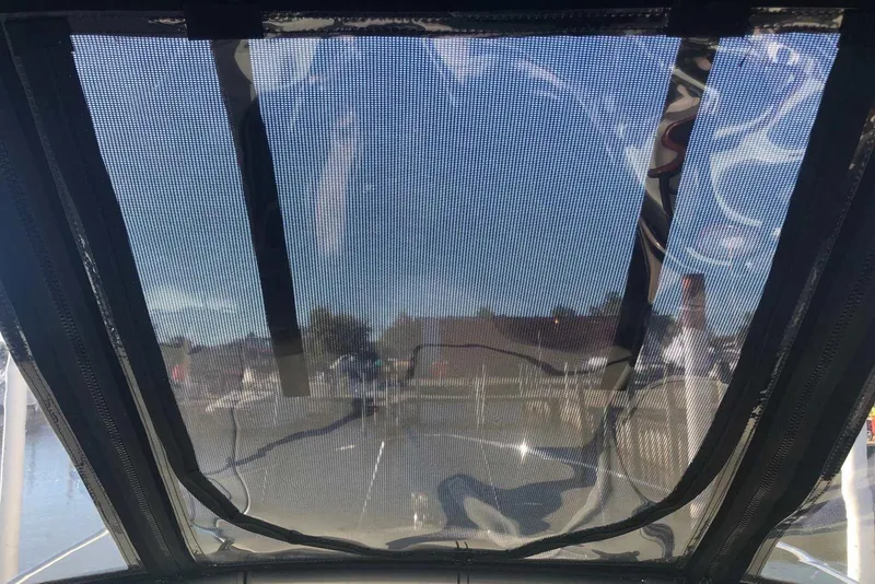 Slide: The Image of View through mesh canopy of 2005 Sea Ray 280 Sundancer boat, docked at marina. - 22