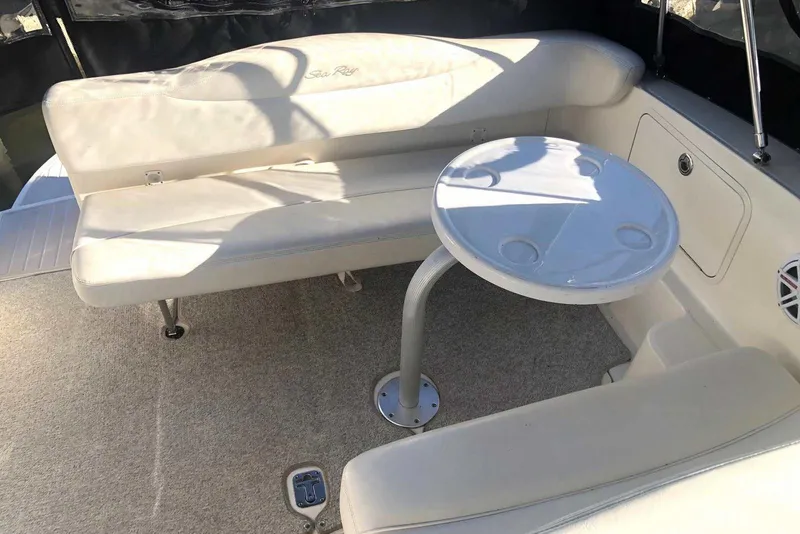 Slide: The Image of 2005 Sea Ray 280 Sundancer interior with white seating and round table. - 23
