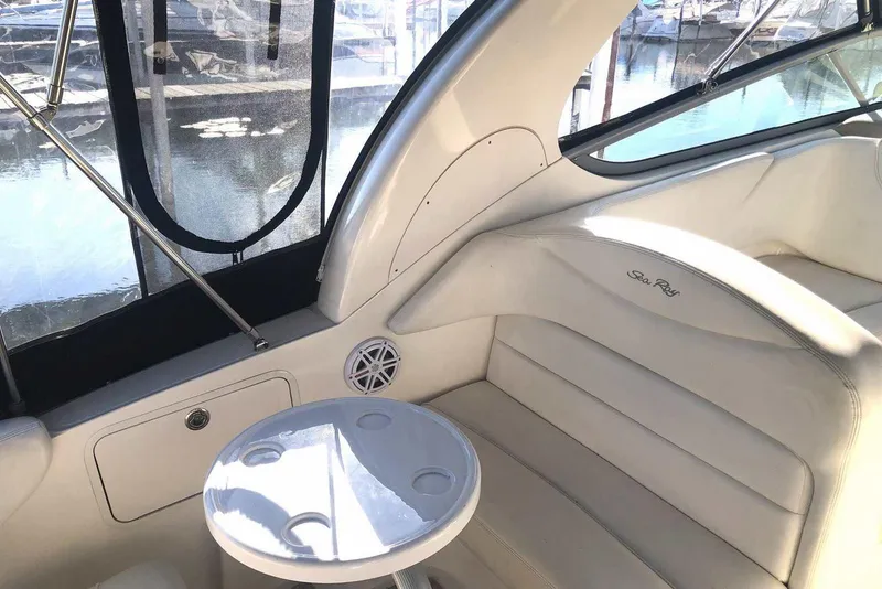 Slide: The Image of 2005 Sea Ray 280 Sundancer interior with white seating and round table. - 25