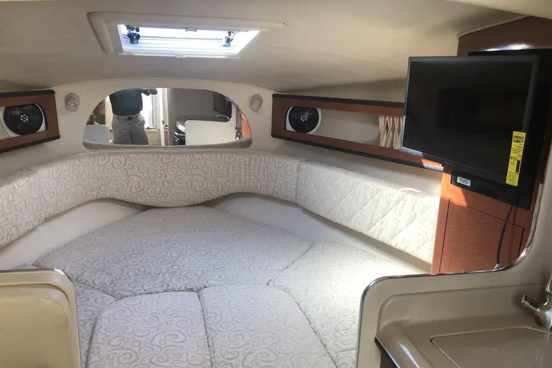 Slide: The Image of 2005 Sea Ray 280 Sundancer cabin interior with bed, TV, and skylight. - 31