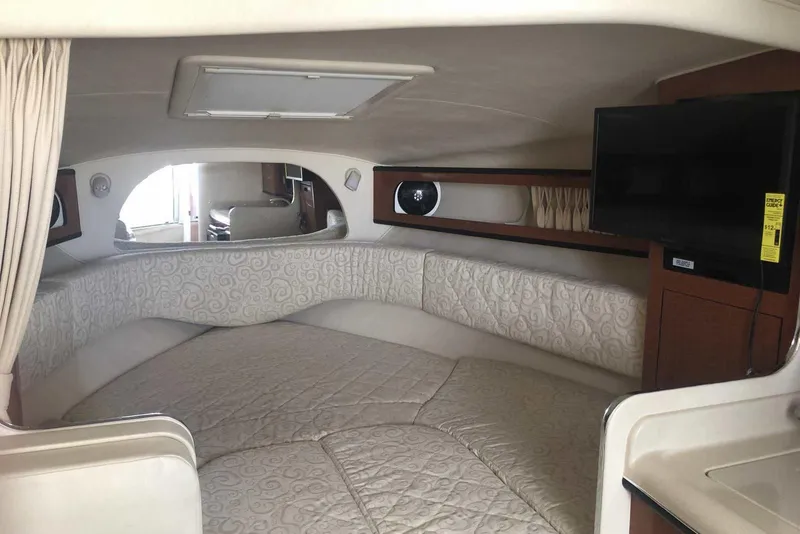 Slide: The Image of Interior of 2005 Sea Ray 280 Sundancer with cozy bed and mounted TV. - 33