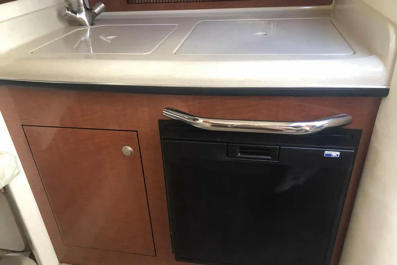 Slide: The Image of 2005 Sea Ray 280 Sundancer kitchenette with sink and mini fridge. - 40