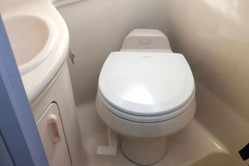 Slide: The Image of 2005 Sea Ray 280 Sundancer bathroom with toilet and sink. - 44