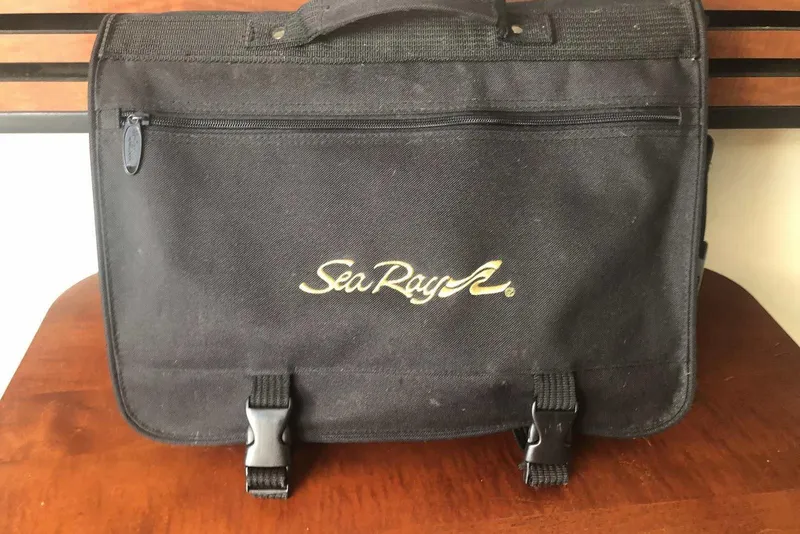 Slide: The Image of Black Sea Ray branded bag on wooden surface, associated with 2005 Sea Ray 280 Sundancer. - 50