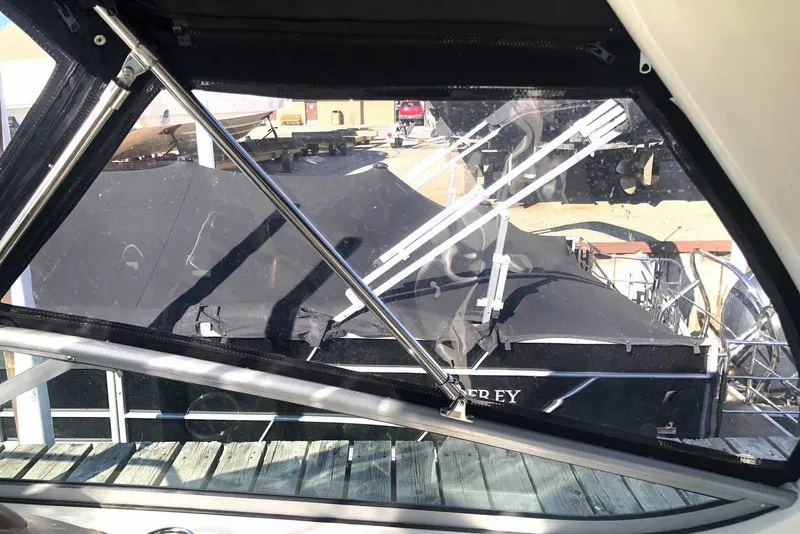 Slide: The Image of 2005 Sea Ray 280 Sundancer interior view with docked boats outside. - 8