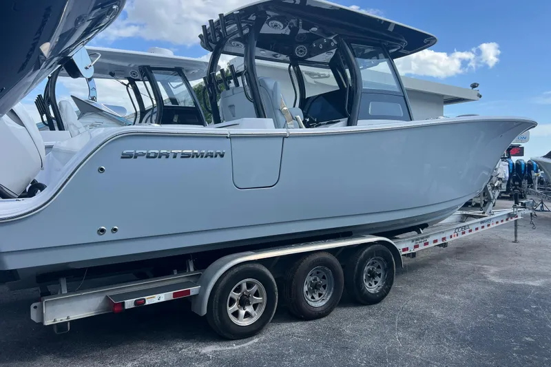 Slide: The Image of 2026 Sportsman Open 302 Center Console boat on a trailer, side view. - 1