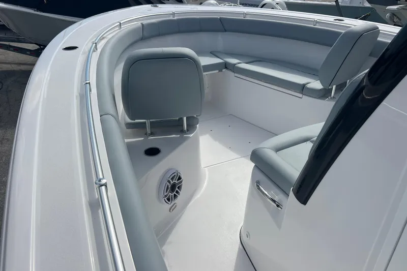 Slide: The Image of 2026 Sportsman Open 302 Center Console boat interior with cushioned seating and speaker. - 10