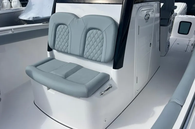 Slide: The Image of 2026 Sportsman Open 302 Center Console boat with cushioned seating and sleek design. - 13