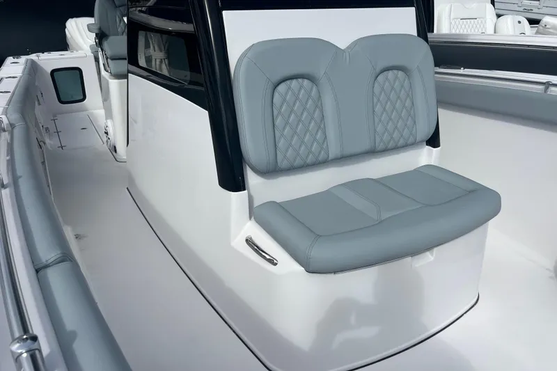 Slide: The Image of 2026 Sportsman Open 302 Center Console with gray cushioned seating. - 14