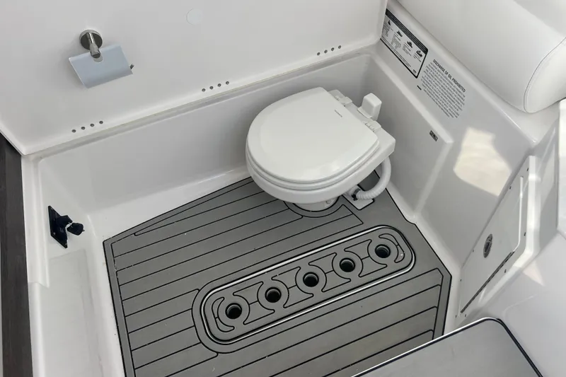 Slide: The Image of 2026 Sportsman Open 302 Center Console boat interior with modern marine toilet. - 21