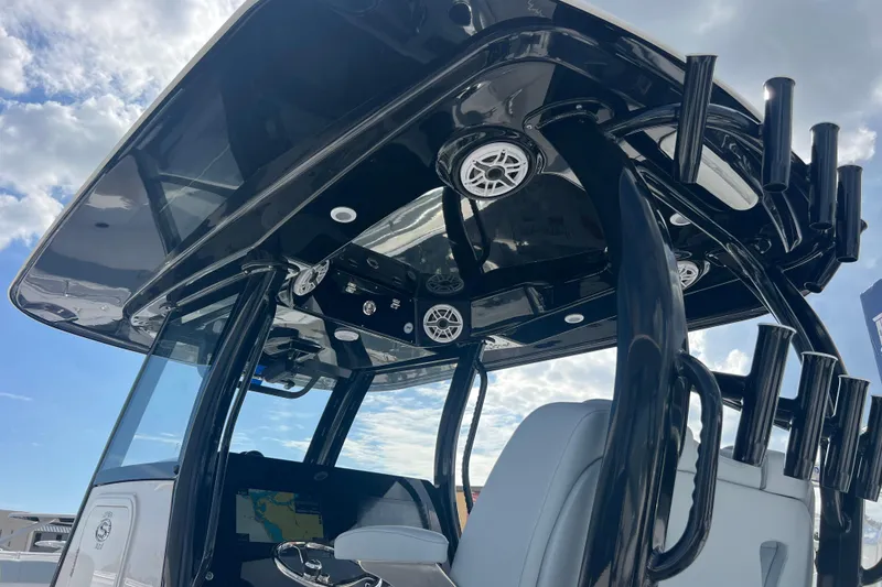 Slide: The Image of 2026 Sportsman Open 302 Center Console boat with sleek black T-top and modern features. - 22