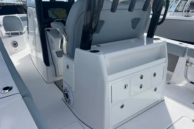 Slide: The Image of 2026 Sportsman Open 302 Center Console boat interior with storage compartments and seating. - 6
