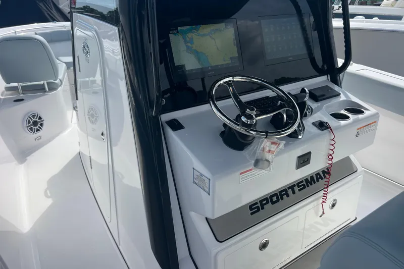 Slide: The Image of 2026 Sportsman Open 302 Center Console boat interior with steering wheel and navigation display. - 7