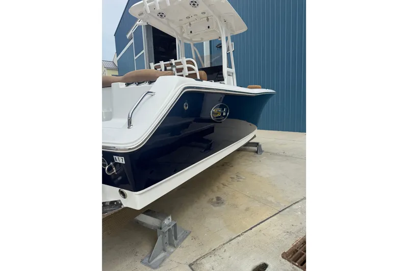 Slide: The Image of 2017 Sea Hunt Ultra 225 boat hull near blue building. - 11