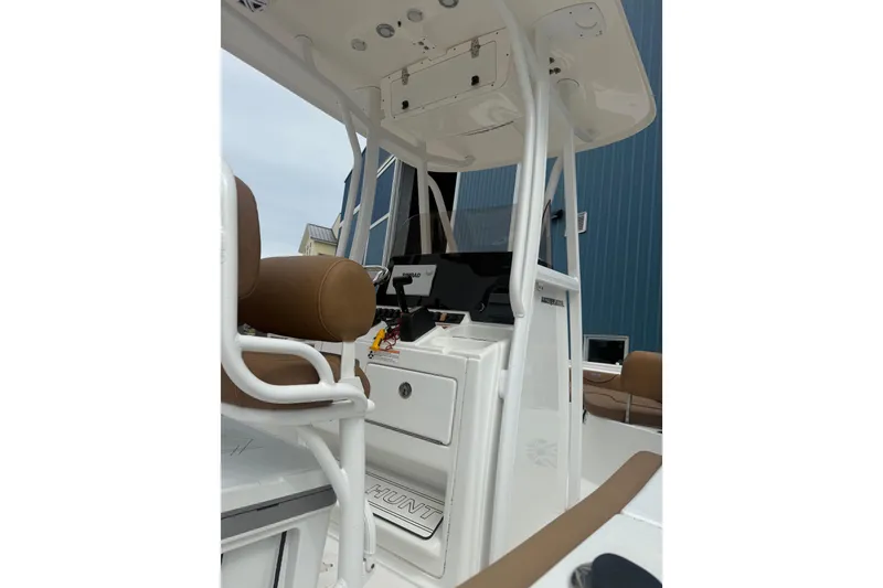 Slide: The Image of 2017 Sea Hunt Ultra 225 boat on dry dock under cloudy sky. - 12