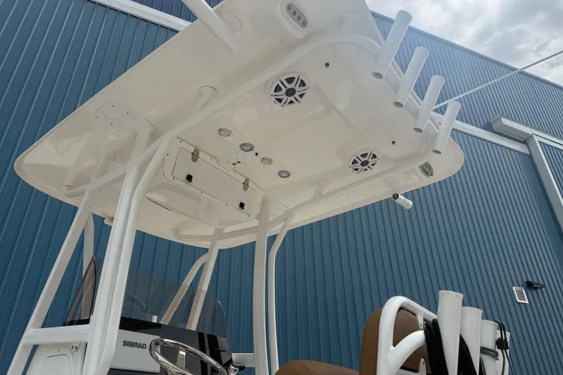 Slide: The Image of 2017 Sea Hunt Ultra 225 with Yamaha four-stroke outboard motor, docked near blue building. - 6