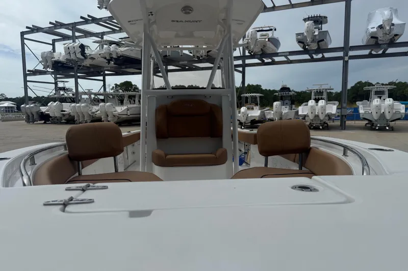 Slide: The Image of 2017 Sea Hunt Ultra 225 boat on display, blue hull, docked on concrete. - 8