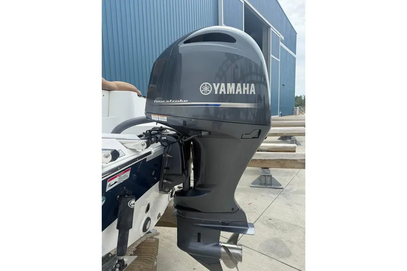 Slide: The Image of 2017 Sea Hunt Ultra 225 boat interior with brown seating and control console. - 9