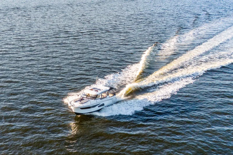 Slide: The Image of Aerial view of 2021 Jeanneau NC 1095 cruising on open water. - 10