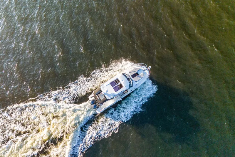 Slide: The Image of Aerial view of 2021 Jeanneau NC 1095 motorboat cruising on open water. - 30
