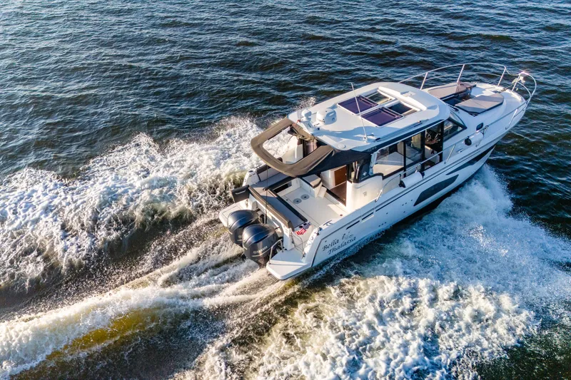 Slide: The Image of 2021 Jeanneau NC 1095 cruising on open water, showcasing sleek design and powerful engines. - 4