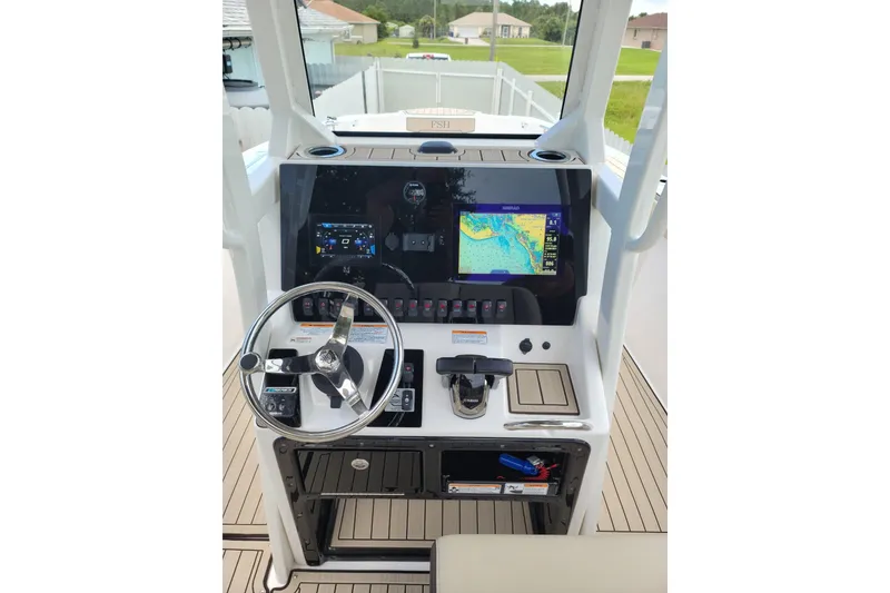 Slide: The Image of 2022 Yamaha Boats 255 FSH Sport E dashboard with navigation display and controls. - 3