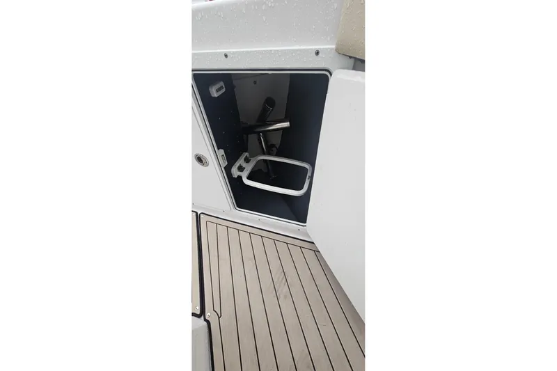 Slide: The Image of 2022 Yamaha Boats 255 FSH Sport E storage compartment with teak flooring. - 9