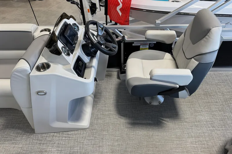 Slide: The Image of Captain's seat and helm of 2026 Avalon Venture 85 CR boat, featuring modern controls and comfortable seating. - 6