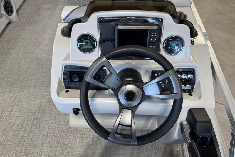 Slide: The Image of Steering console of 2026 Avalon Venture 85 CR boat with modern controls and gauges. - 7